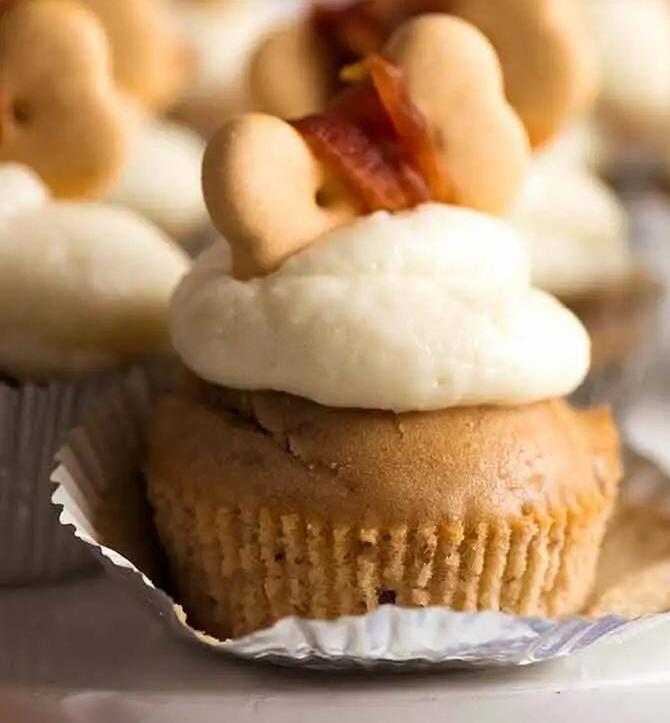 A Special PupCake with a biscuit cookie on top, white icing that is both cruelty-free and safe to eat for pets is layed nicely on the PupCake!